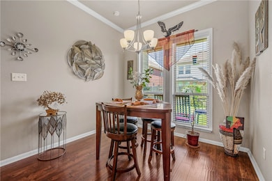 Dining room with wood finished floors, ornamental