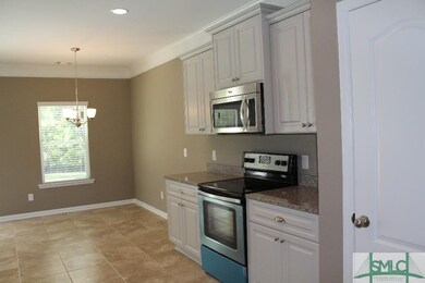 Beautiful gray cabinets in kitchen, open to breakf