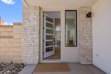 Property entrance featuring stucco siding and stone siding