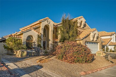 Mediterranean / spanish house with an attached gar