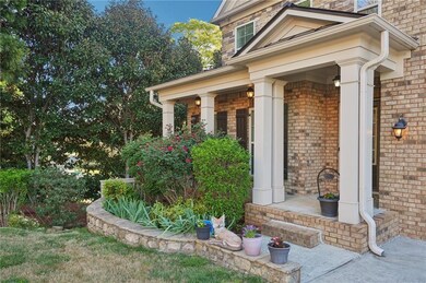 Entrance to property with brick siding and a porch
