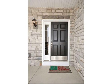 Exterior Front. Stone doorway with concrete front 