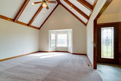 High ceiling with exposed beams in the living room.  Plenty of space for the Christmas tree!