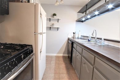 Kitchen featuring a sink, dishwashing machine, op