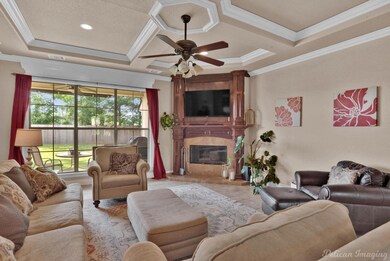 Tiled living room featuring crown molding, coffere
