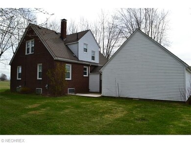 Side yard with patio and an attached two car garage.