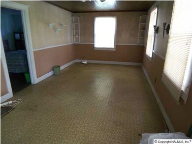 Great room features ceiling fan, crown molding and chair rail