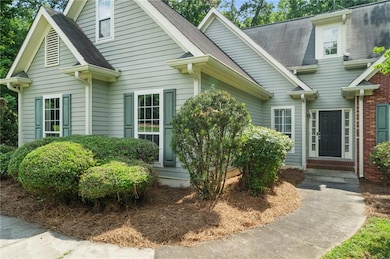View of front of house with a shingled roof