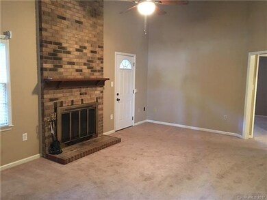 Family room with wood burning fireplace and vaulte