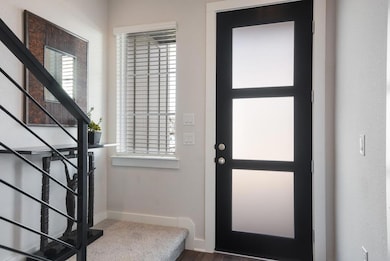 Entrance foyer with stairs, baseboards, and a hea