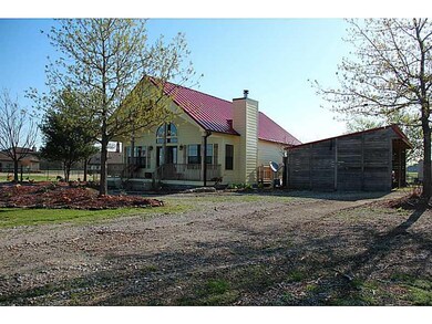 Exterior Front. Detached covered car port has elec