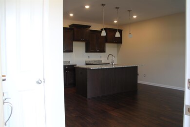 View of the kitchen from the front door.  Half bath is to the left.  Similar home.