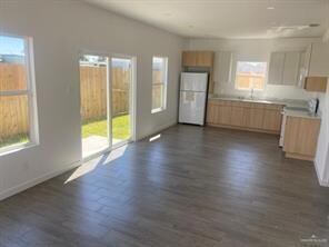 Kitchen featuring dark wood-type flooring, white f