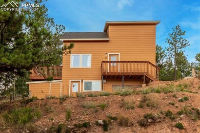 Back of house featuring a wooden deck