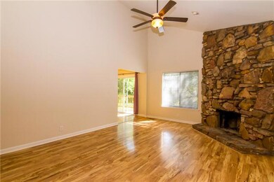 Light and bright with gorgeous laminate wood flooring, a vaulted ceiling adding to the spaciousness, and a wonderful stone fireplace to cozy up to.  Freshly painted throughout!