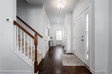 Foyer Leading to Powder Room and Door to Garage