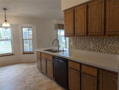 Eat-in Kitchen with tile backsplash and vaulted ce