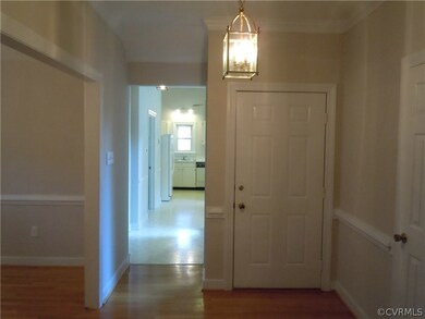 Foyer with hardwood floor and coat closet