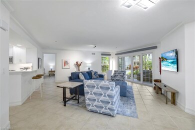 Living area with crown molding and light tile patterned floors