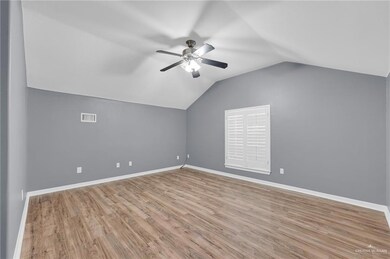 Bonus room featuring ceiling fan, vaulted ceiling, baseboards, and wood finished floors