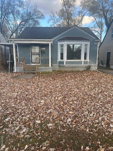 Rear view of property featuring covered porch
