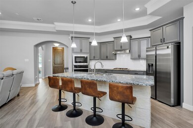 View of entry hall opening into open-plan living area
