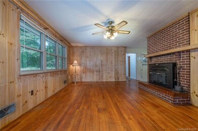 Living Room with woodstove insert, wood flooring a