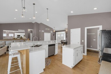 Open concept main level with soaring ceiling heights, hardwood flooring and updated kitchen.