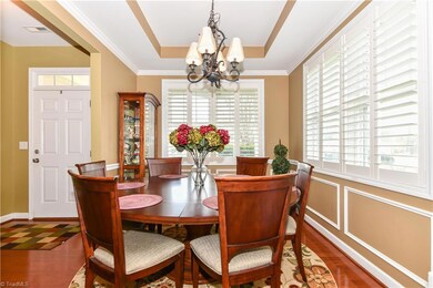 Dining room with trey ceiling and Plantation shutters.