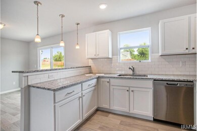 The kitchen is equipped with granite counters, acc
