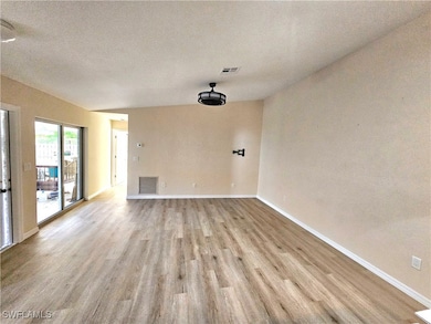 Unfurnished living room with light wood finished f