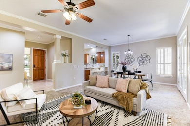 Living area with ornamental molding, light colore