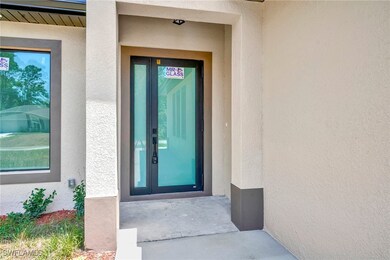 Property entrance featuring stucco siding