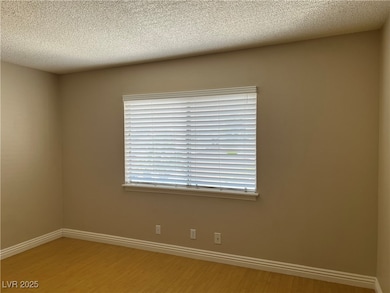 Empty room featuring light wood finished floors, b