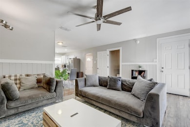 Living room with a wainscoted wall, light wood-ty