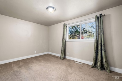 Carpeted empty room with baseboards