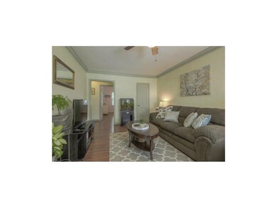 The wood floors flow into the dining room.