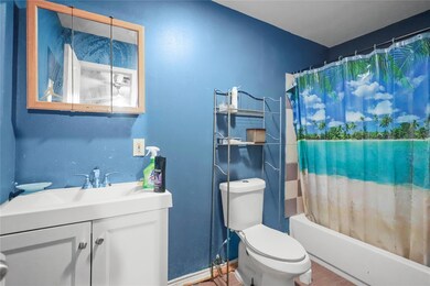 Full bathroom with hardwood / wood-style flooring,