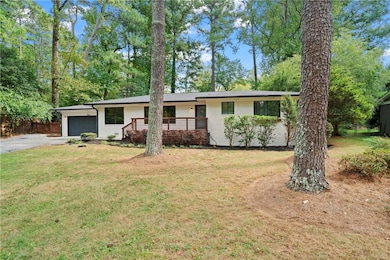 Ranch-style home with a garage and a front lawn