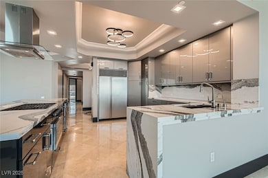Kitchen featuring chimney ZEPHR exhaust hood, soak