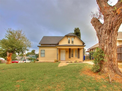 View of front of property with covered porch and roof with shingles