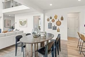 Dining space with wood finished floors and recessed lighting