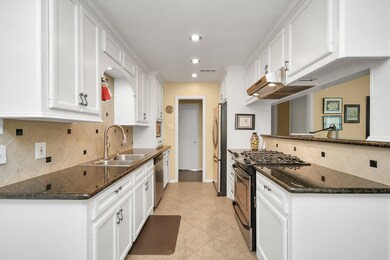 The kitchen boasts gorgeous granite countertops an