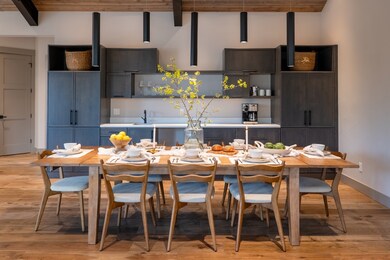 Dining space featuring beamed ceiling and light wood-type flooring