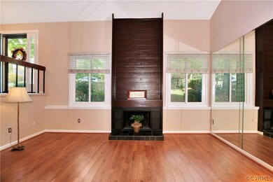 The dramatic wood-burning fireplace is the centerp