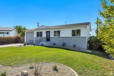 View of front of property featuring brick siding, concrete driveway, and a garage