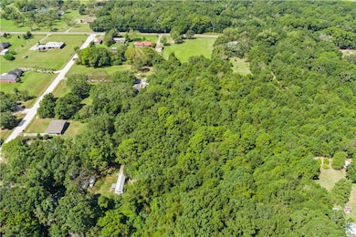 Aerial view of property's location featuring a forest