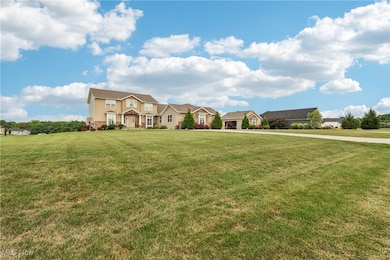 Traditional-style home with a front lawn, a residential view, and stone siding