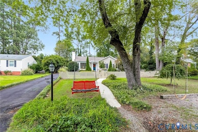 View of house with fenced front yard and overflow parking