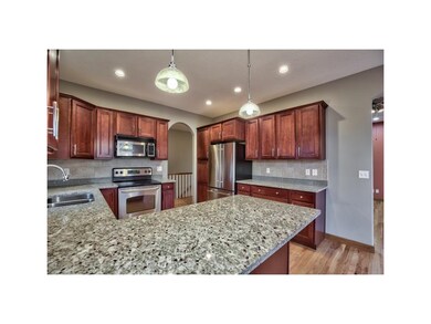 GRANITE COUNTERS, MAPLE CABINETRY WITH CROWN